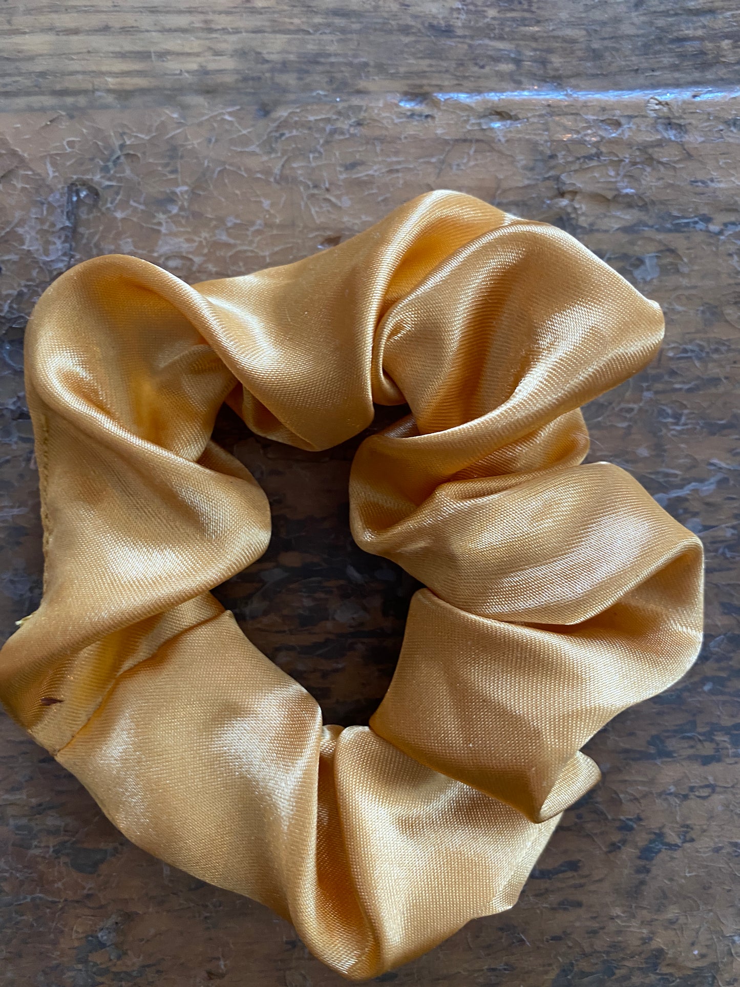 Caramel coloured satin scrunchy hair tie