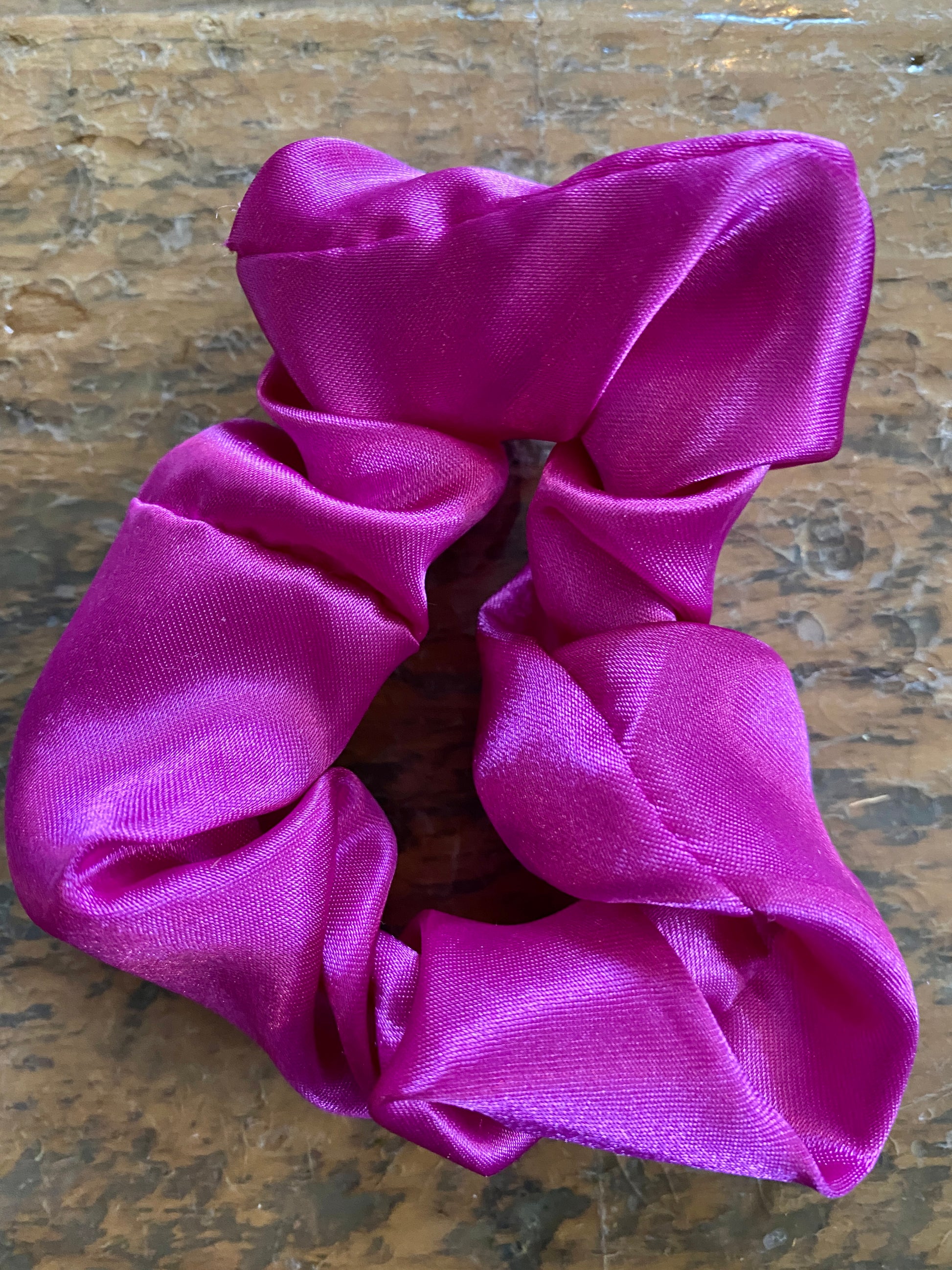 Magenta satin scrunchy hair tie.