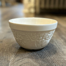 Load image into Gallery viewer, Photo containing a small mixing bowl. Made of white glazed ceramic. Forest scene surrounds the bowl with details of trees, leaves, and foxes.
