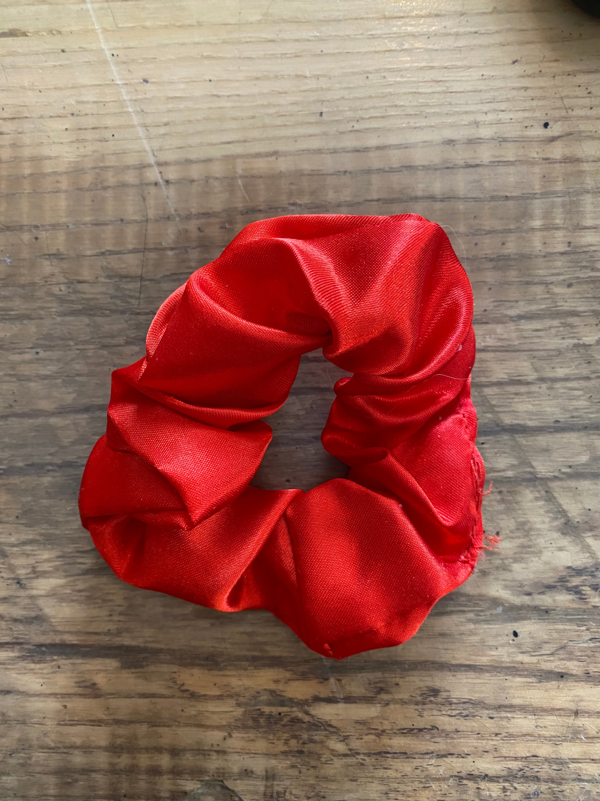 Bright red satin scrunchy hair tie