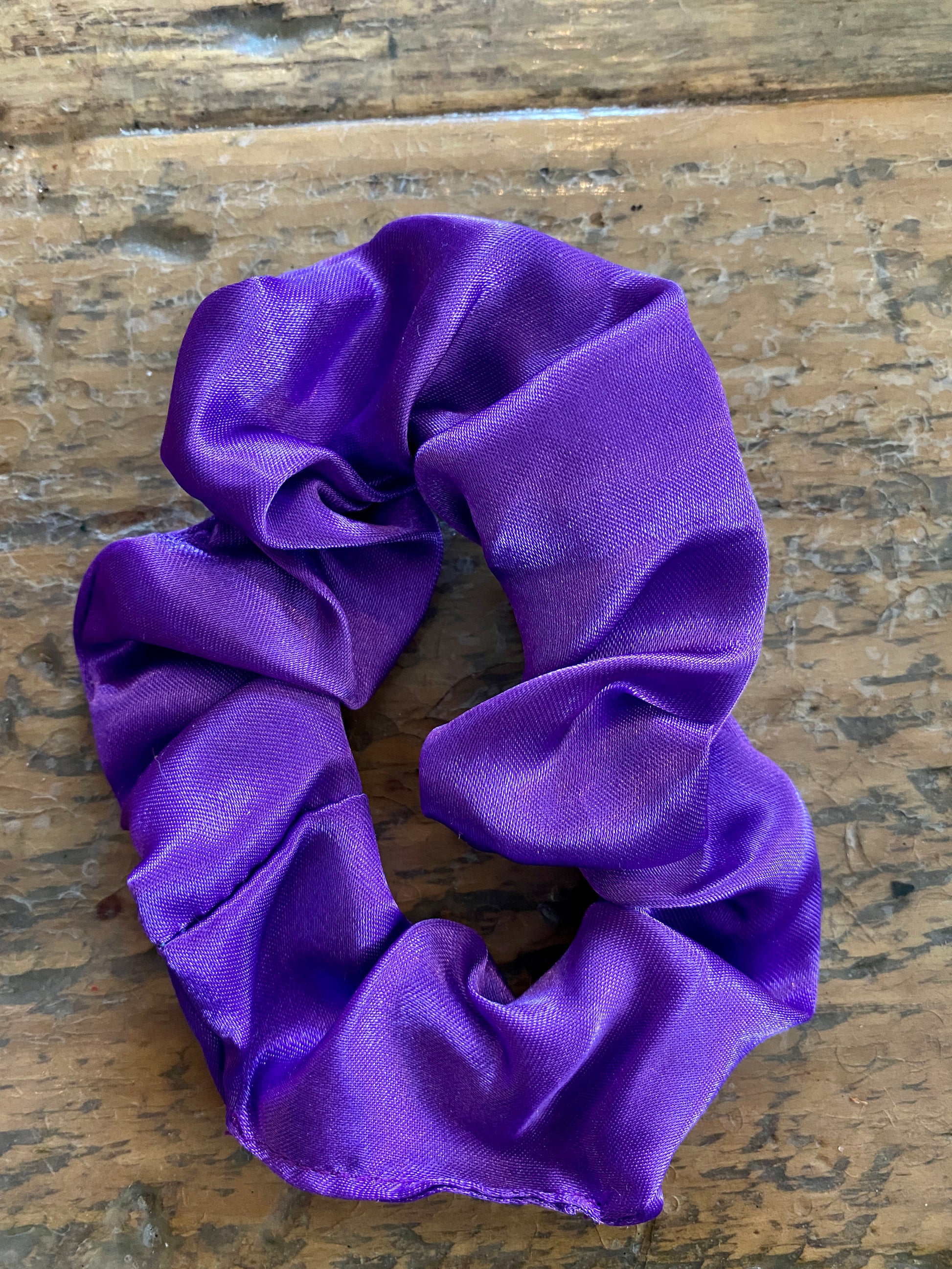 Purple satin scrunchy hair tie.