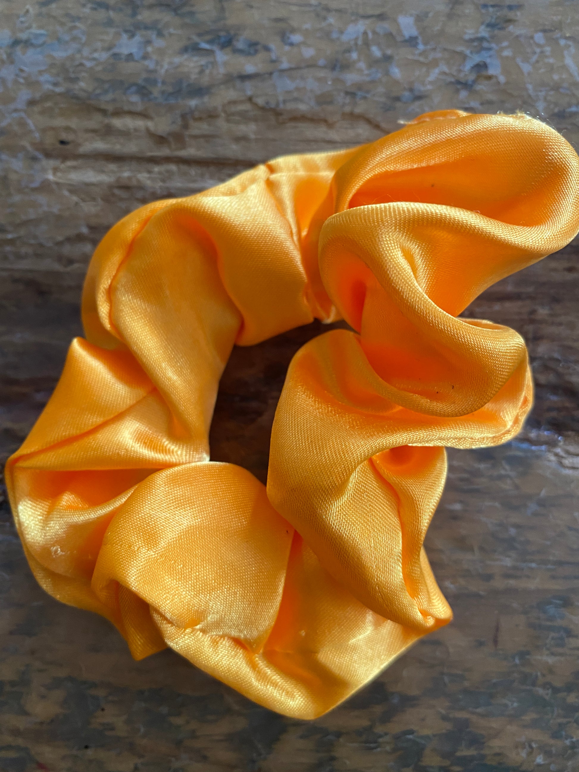 Yellow satin scrunchy hair tie.